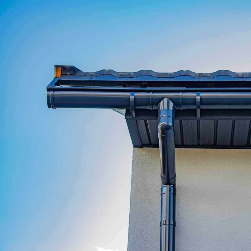 Close-up of black gutter system on residential roof.