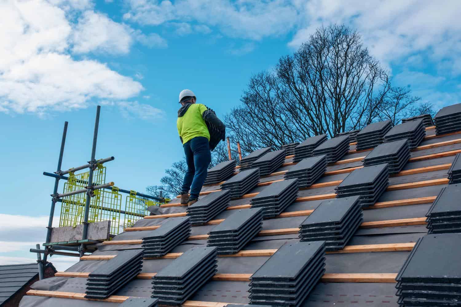 Roofer installing tiles on a residential roof
