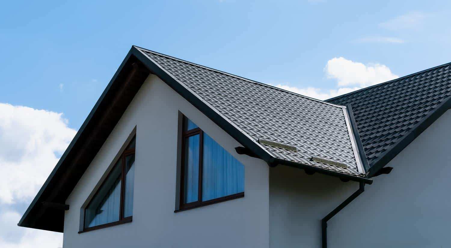 Contemporary house roof with metal shingles and large windows in Fountain, CO.