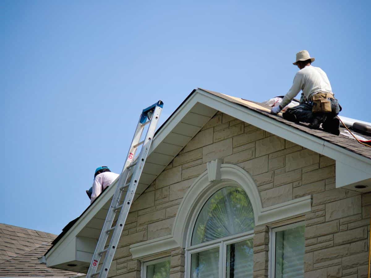Roofing professionals working on a house in Parker, Colorado.