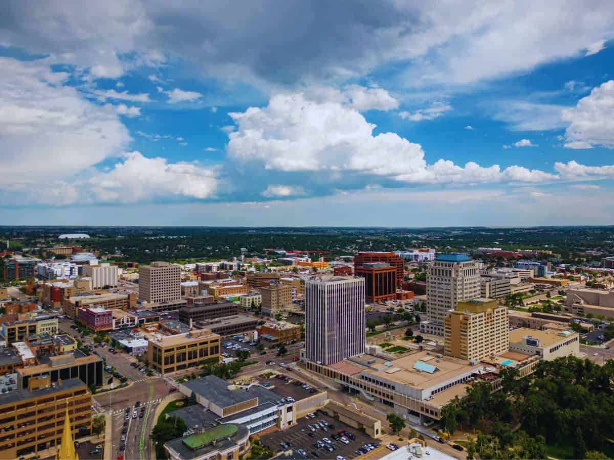 Aerial view of El Paso County cityscape under a partly cloudy sky.
