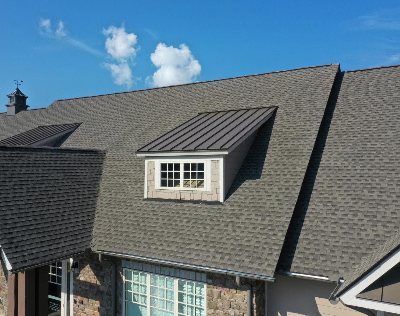 Modern roof with dormer window and metal roofing in Colorado Springs.