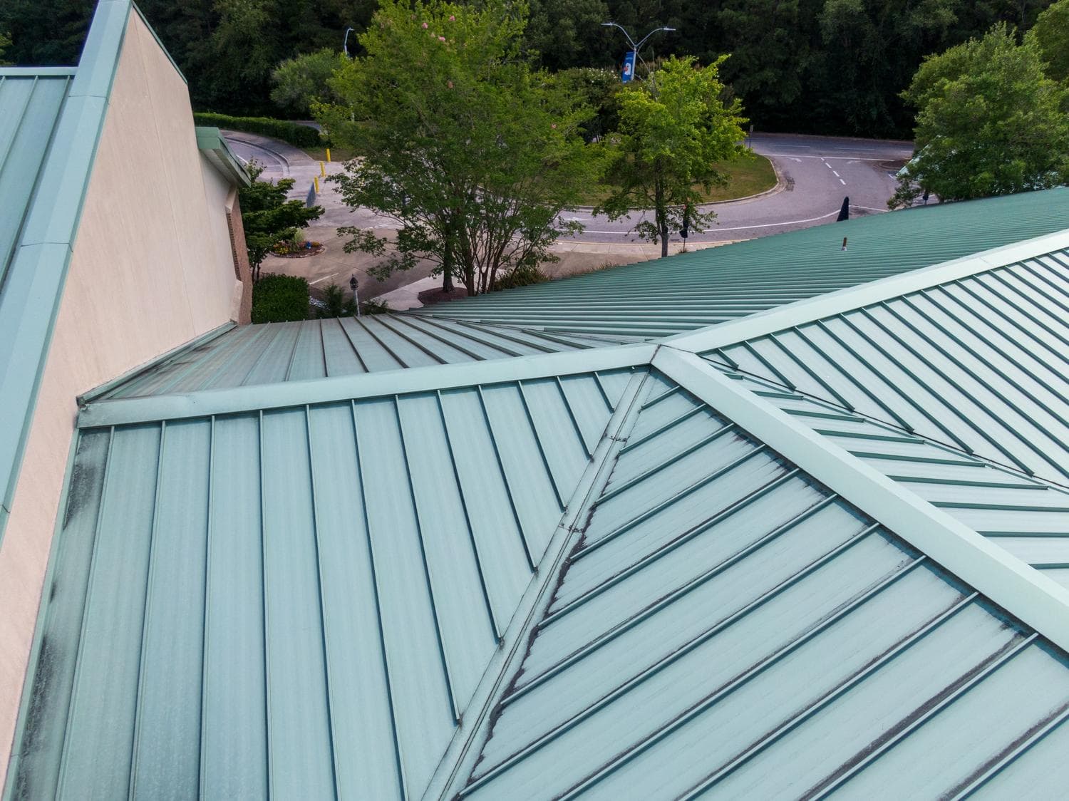 Metal roof with green panels on a residential building in Colorado Springs.