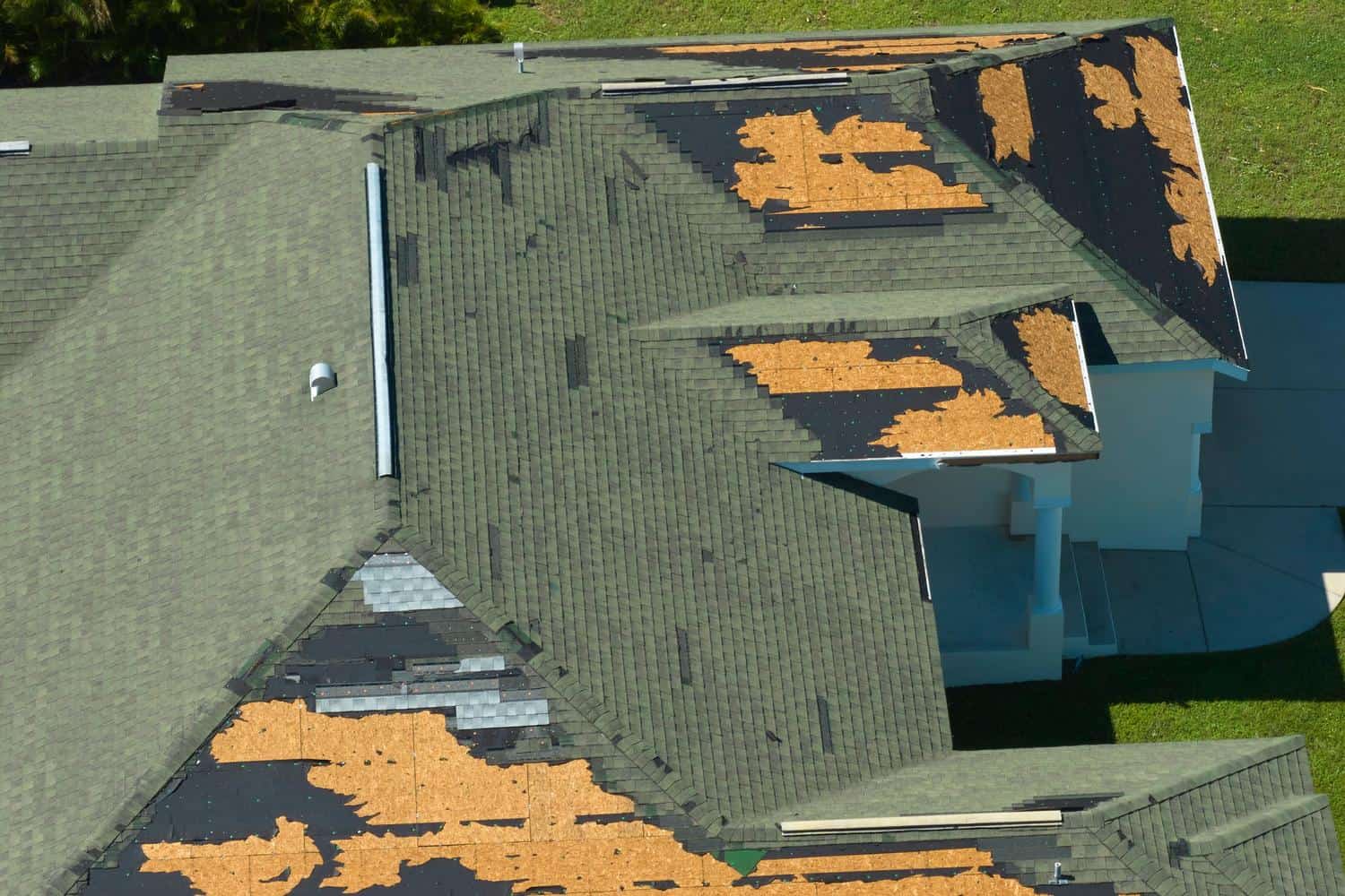 Damaged roof with missing shingles during roof replacement in Parker, CO.