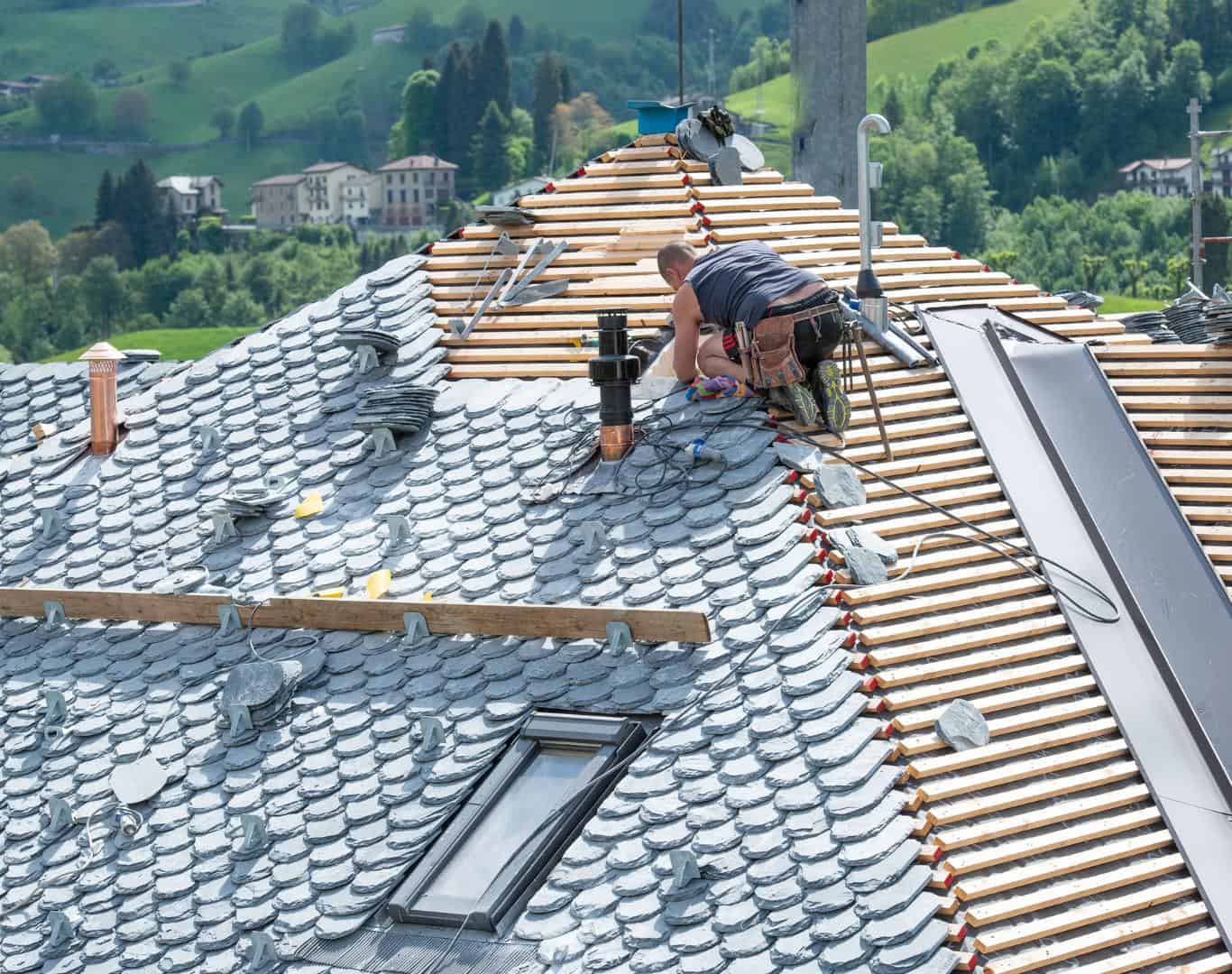 Roofing contractor installing new shingles on a residential roof in Highlands Ranch, CO.